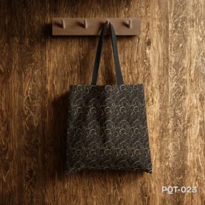 Mystic Wave Tote Bag (PQT-023) featuring a dark grey or black background with a repeating pattern of small, abstract crescent moon or wave-like shapes in gold, beige, and muted purple/pink, with black handles, hanging from a light wooden peg rack against a dark, textured wooden plank wall.