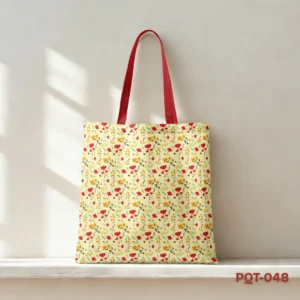 Sunshine Bloom Tote Bag (PQT-048) featuring a repeating pattern of small red, orange, and yellow stylized flowers with green leaves on a light cream background, with bright red handles, displayed upright on a light-colored shelf against a sunlit beige wall.