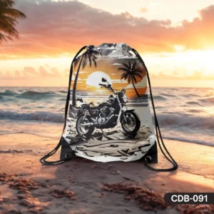 Coastal Cruise drawstring bag featuring a detailed print of a classic motorcycle parked on a sandy beach with palm trees against a vibrant sunset over the ocean.
