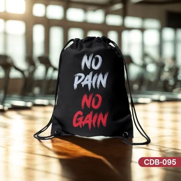 Iron Will black drawstring bag with 'NO PAIN NO GAIN' printed in bold white and red distressed lettering, displayed on a wooden surface in a gym.