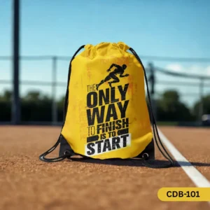 Momentum Maker yellow drawstring bag with 'The Only Way To Finish Is To START' quote, displayed on a running track."
