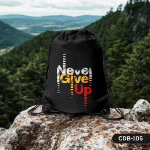 "Peak Persistence black drawstring bag with 'Never Give Up' in colorful text, displayed on a rock with a mountain landscape background."