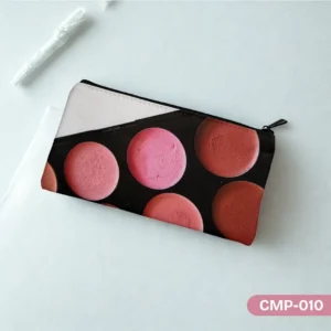 Rosy Radiance Makeup Pouch (CMP-010) with a blush palette print in shades of pink and coral, displayed on a light teal surface with a white pen and paper in the background.