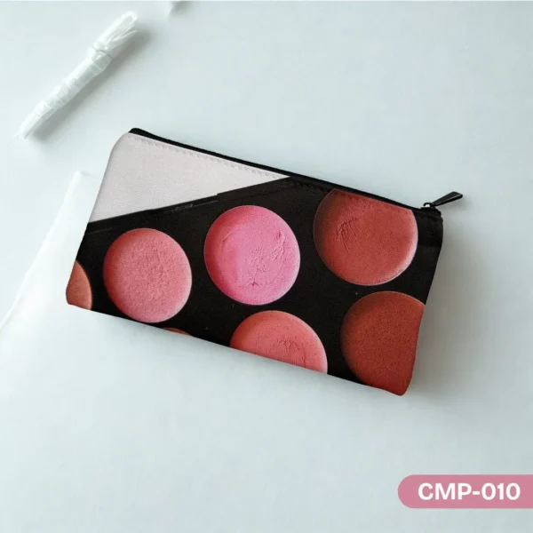 Rosy Radiance Makeup Pouch (CMP-010) with a blush palette print in shades of pink and coral, displayed on a light teal surface with a white pen and paper in the background.