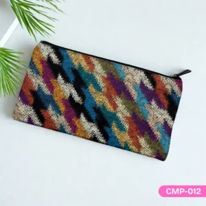 Woven Prism Makeup Pouch (CMP-012) showcasing its colorful, textured digital print on a light background with a plant accent.