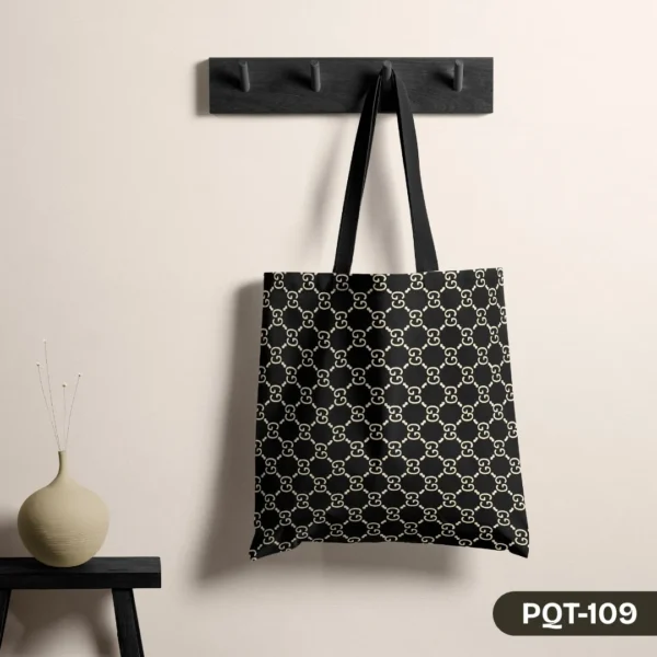 "The Initial Statement Tote Bag with Cream GG Monogram Print on Black Background PQT-109", "Designer Inspired Black Tote Bag featuring Interlocking G Initial Pattern", "Durable Polyester Shopping Bag with Classic Luxury Monogram Design PQT-109".