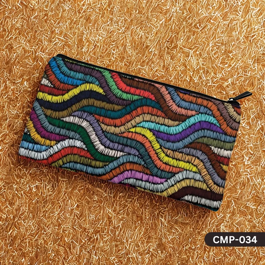 The Color Chorus Makeup Pouch with a vibrant, multi-colored embroidered wave pattern, displayed on a textured golden-yellow background.