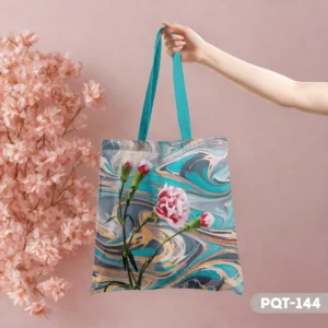 AquaPetal Tote Bag (PQT-144) with a pink carnation design against an aqua, grey, and gold marbled background, held by a hand with pink flowers in the backdrop