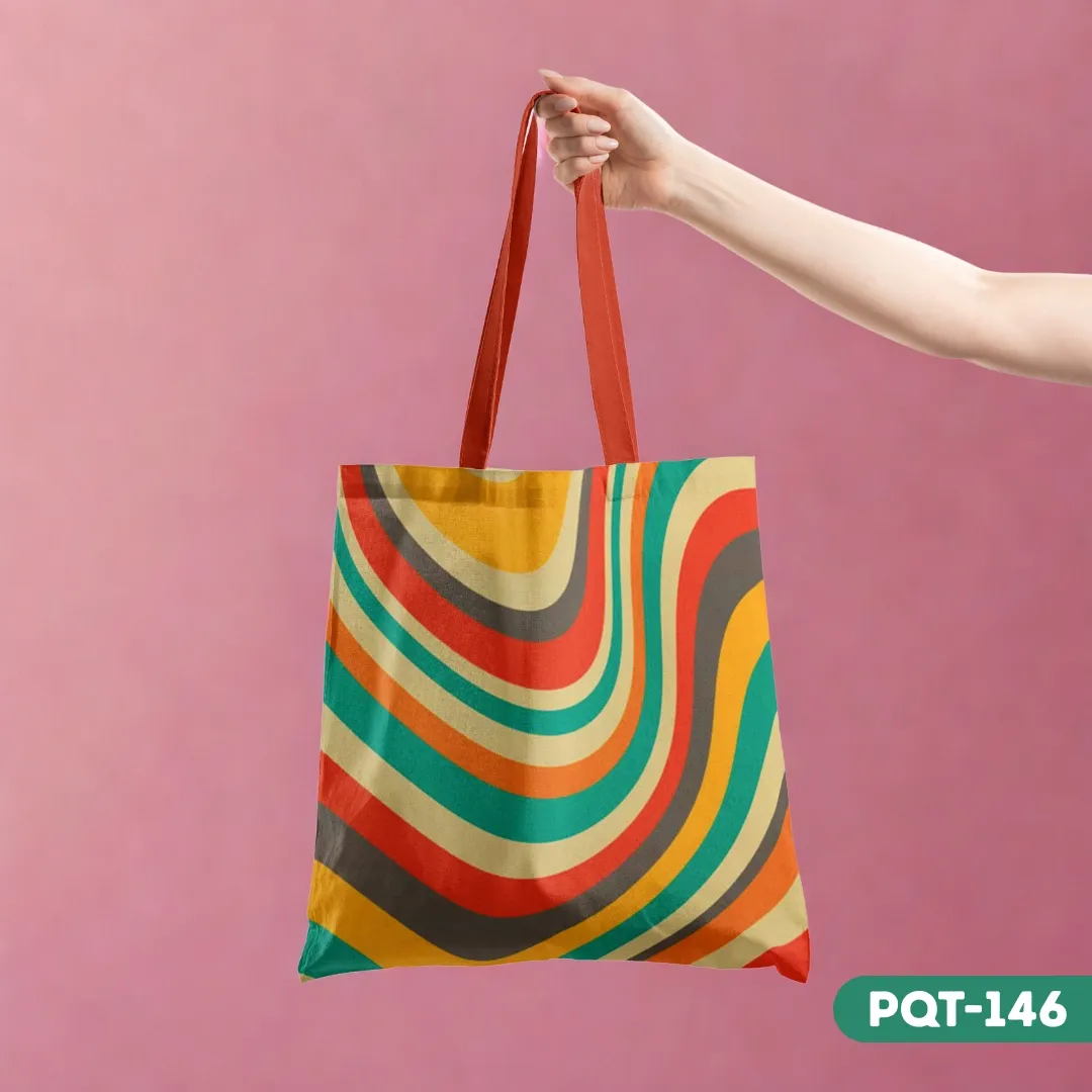 Rhythmic Lines Tote Bag (PQT-146) with a retro 70s-style colorful swirl pattern, held by a hand against a pink background