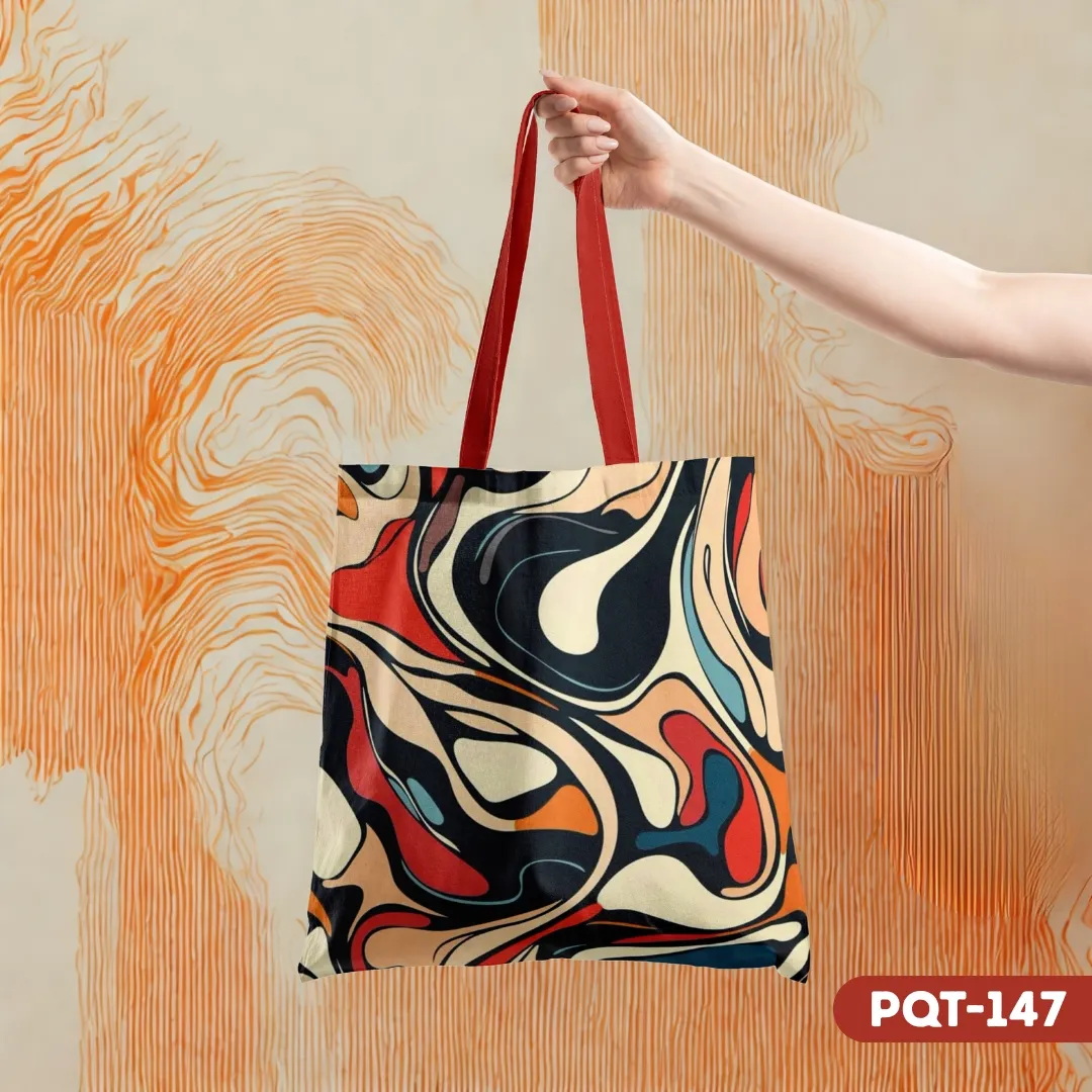 Volcanic Glass Tote Bag (PQT-147) with a dynamic abstract liquid art print in red, black, blue, and cream, held by a hand against an orange textured background.